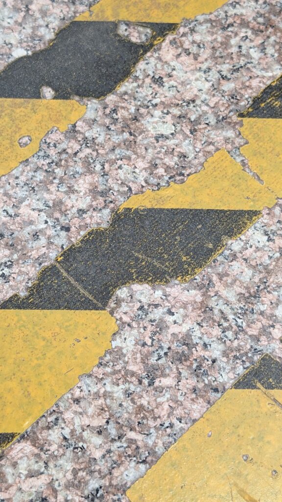 degraded anti-slip tape found during a factory slip hazard inspection