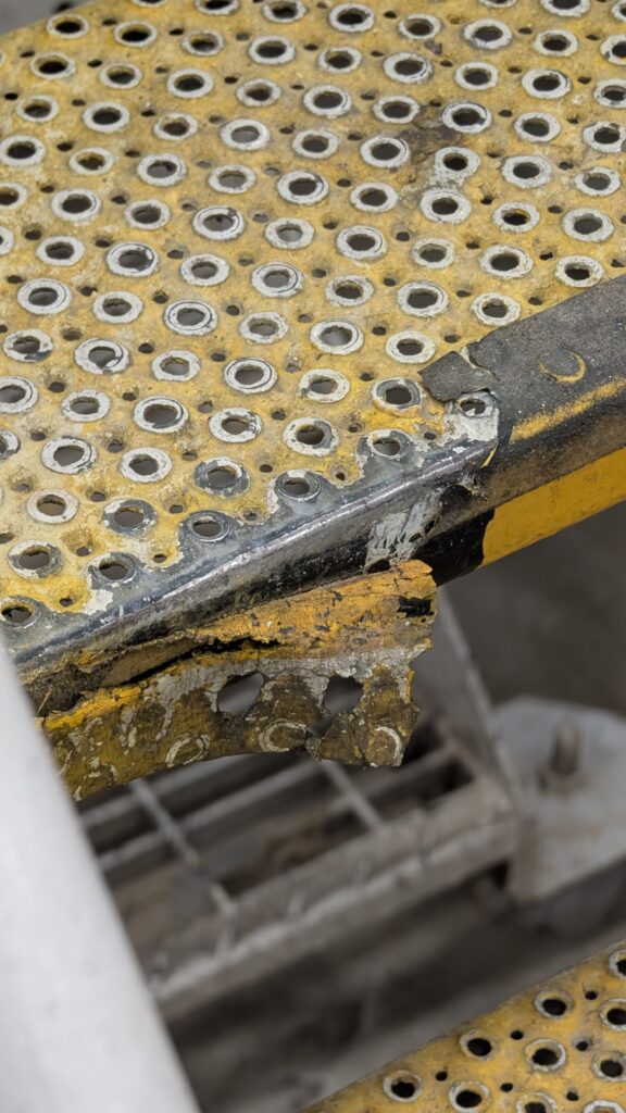 degraded anti-slip tape found during a factory slip hazard inspection